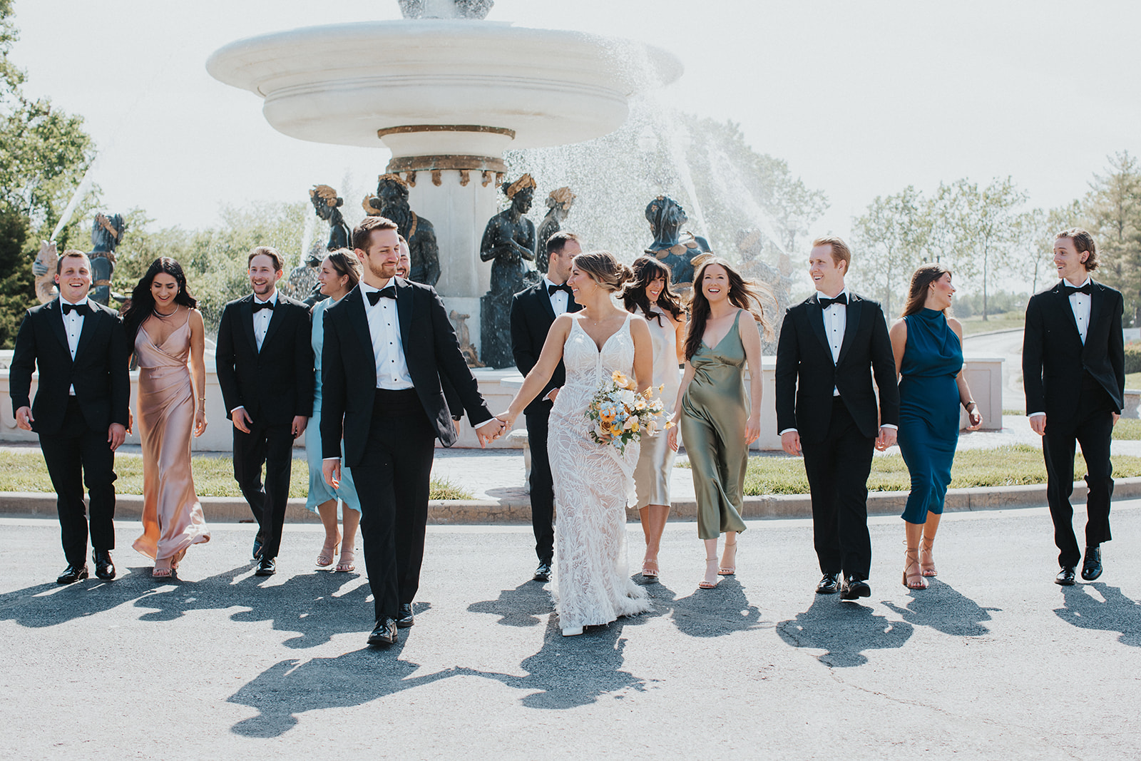 Wedding at Avent Orangery in Kansas City. Bride and Groom walking with Wedding Party